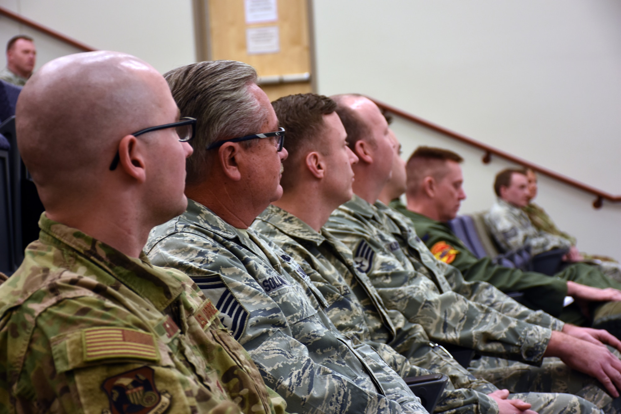 Community College of the Air Force graduates listen to opening remarks during a graduation ceremony at Whiteman Air Force Base, Mo., Dec. 8, 2019.