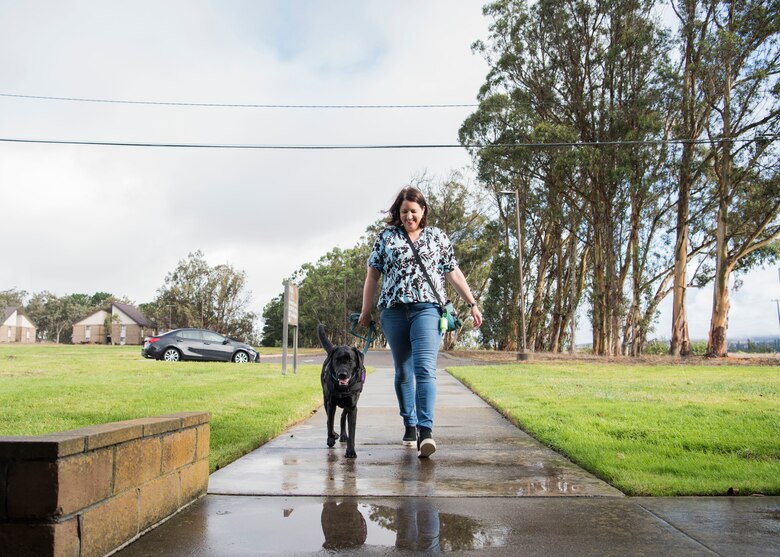 Emily Dreiling, 30th Space Wing sexual assault prevention and response coordinator, and Preston, 30th SW courthouse facility dog, walk toward their office at Vandenberg Air Force Base, Calif., Dec. 4, 2019. Dreiling and Preston work side-by-side at Sexual Assault Prevention and Response office at Vandenberg AFB, helping victims of abuse. (U.S. Air Force photo by Airman 1st Class Aubree Milks)