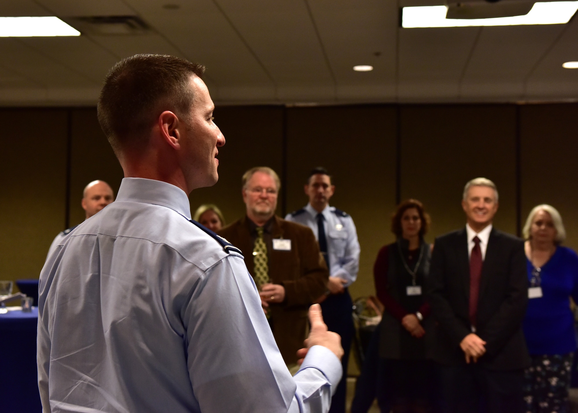 Individuals gather in a room for a meeting