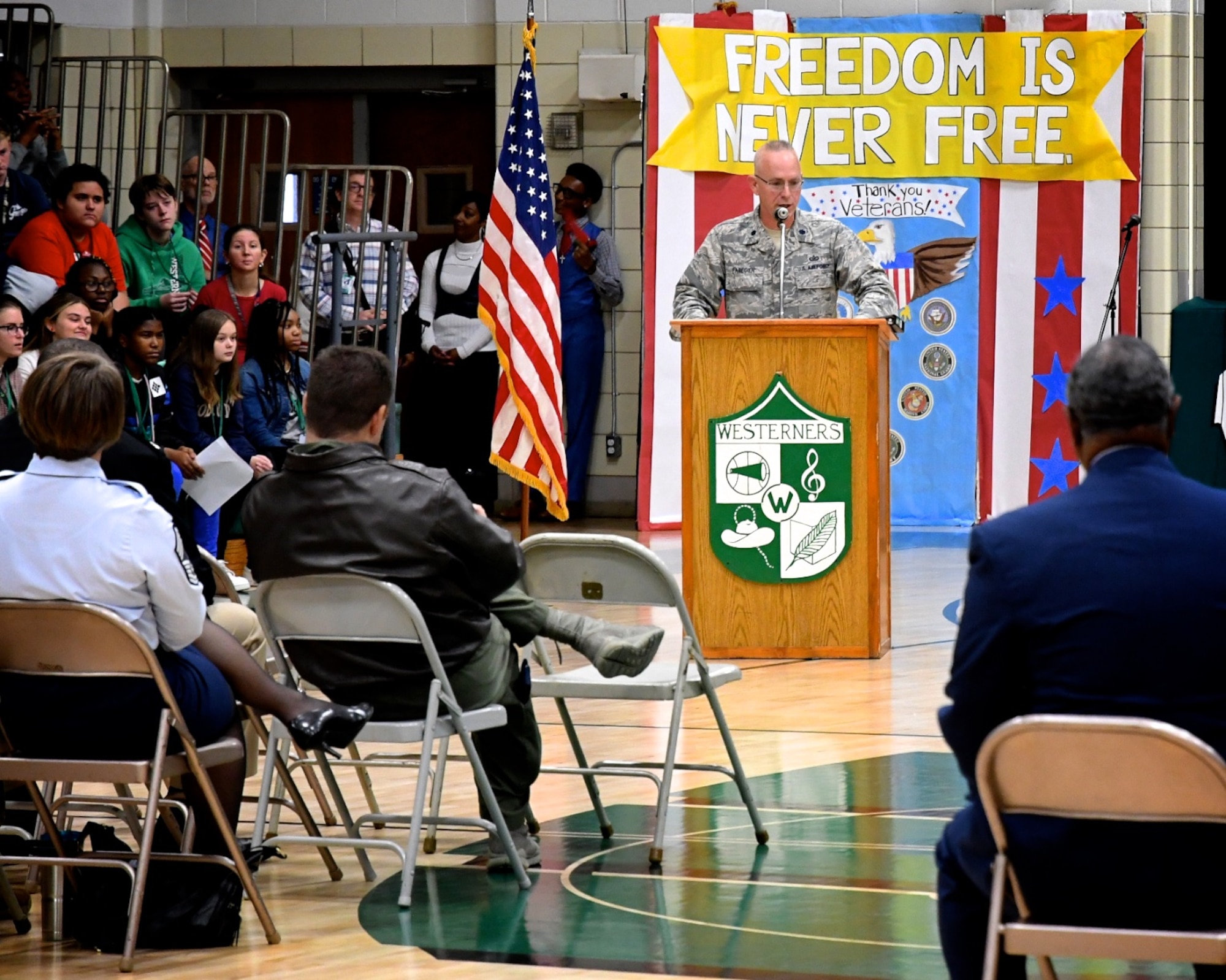 As part of community relations outreach, Lt. Col Stan Paregien from the 932nd Airlift Wing's Public Affairs Office, speaks regarding American veterans to Grant Junior High School students November 6, 2019. Later in the week he was joined at Highland Junior Hight School by a 73rd Airlift Squadron pilot and commander, Lt. Col. Brandon Lorton.   A display booth was set up early in the morning and Paregien answered questions for several hours to multiple rotating classes about the Air Force Reserve. He handed out some military gear for students to pass around, along with an American flag, and answered student's questions about what it takes to become an American Airman during an all day event culminating with a final school assembly, then featuring Lt. Col. Lorton as the keynote speaker interacting with local veterans from the community. (Photo submitted)