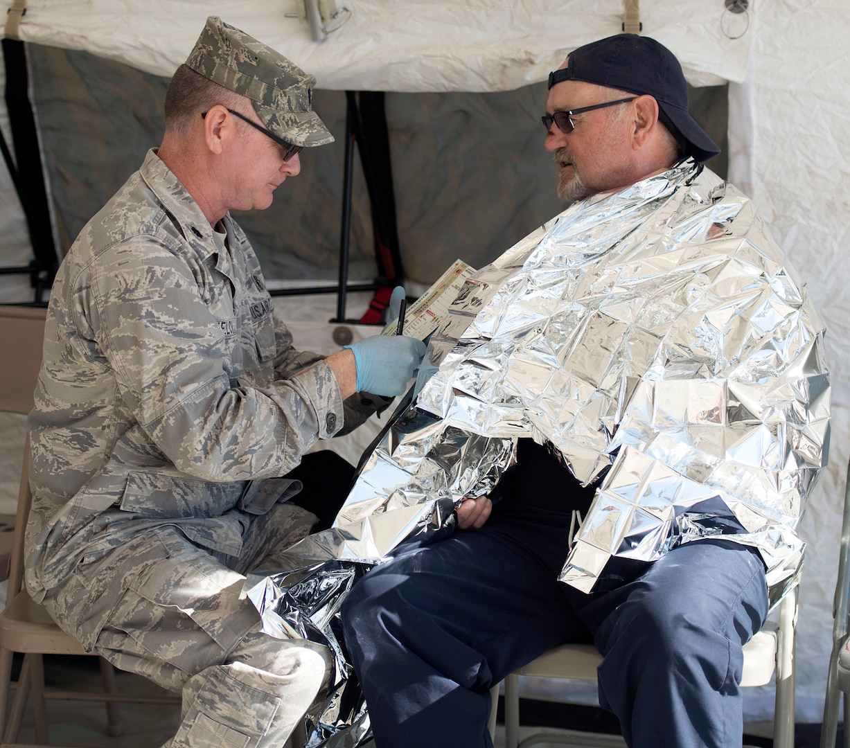 Lt. Col. Todd Welch, a physicians assistant, assigned tothe 149th Medical Group’s Det. 1, simulates providing medical treatment to a role player during the Texas National Guard's 6th CERFP Task Force, which includes the 149th Fatality Search and Recovery Team, participated in a response evaluation exercise Dec. 7, 2019, in Round Rock, Texas.