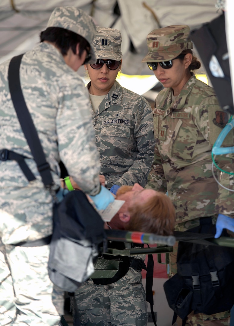 Capt. Gabriela Torres, Capt. Denise Rodriguez and Capt. Araceli Vazquez, all trauma nurses assigned to the 149th Medical Group’s Det. 1, simulates providing medical treatment to a role player during the Texas National Guard's 6th CERFP Task Force, which includes the 149th Fatality Search and Recovery Team, participated in a response evaluation exercise Dec. 7, 2019, in Round Rock, Texas.