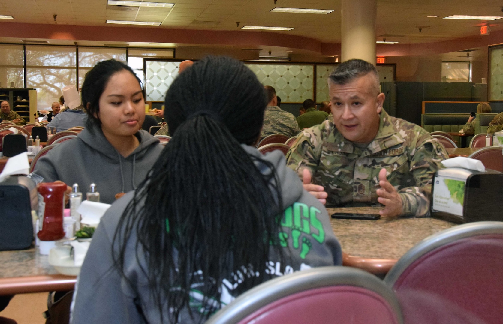 Chief Master Sgt. Miguel A. Casso, 356th Airlift Squadron chief loadmaster, visits with Airmen at the Serve the Airmen event Dec. 7, 2019 at the Live Oak Dining Facility on Joint Base San Antonio-Lackland, Texas.