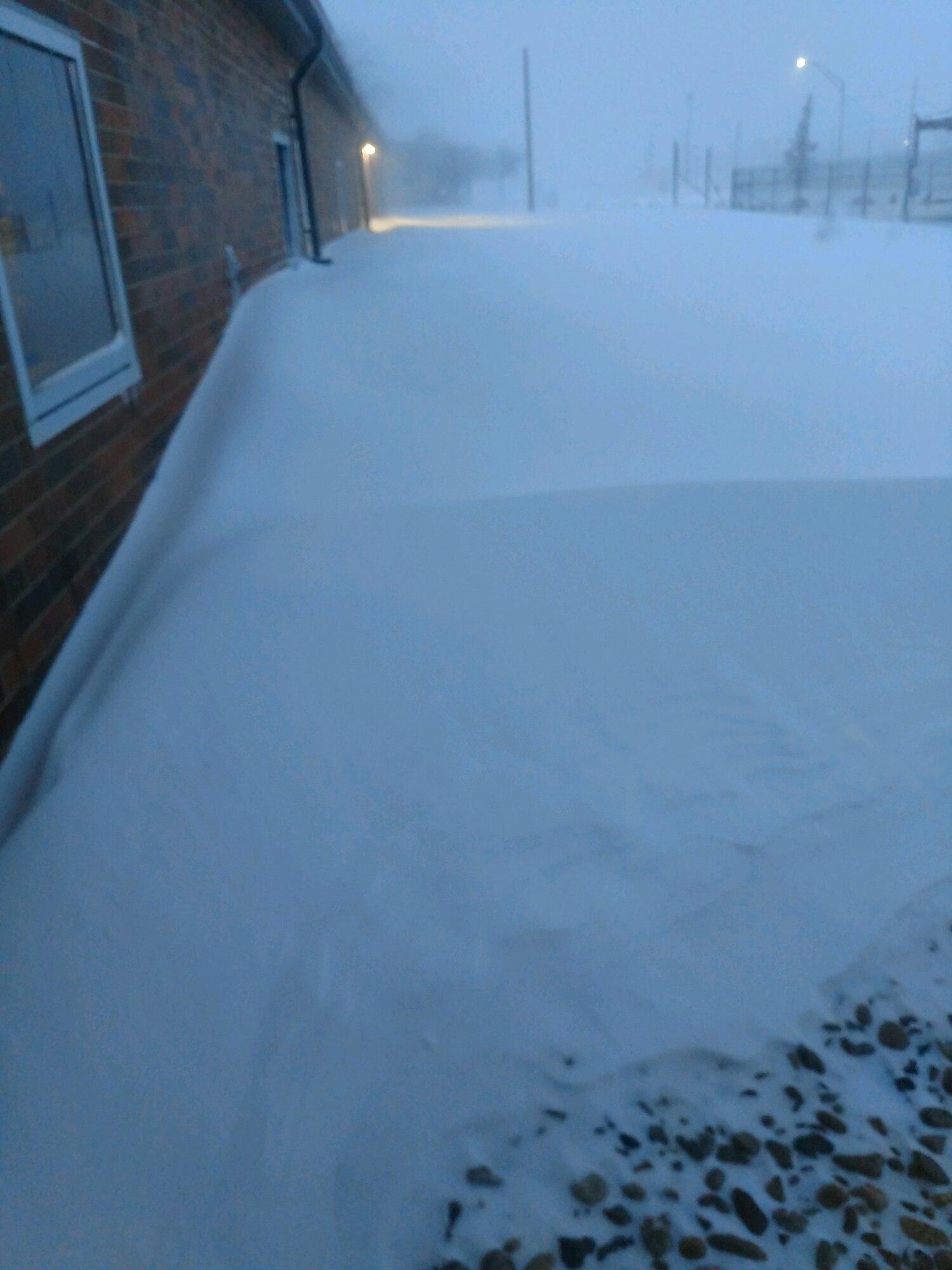 Snow is piled outside the door of a MQ-9 squadron building at Ellsworth Air Force Base.