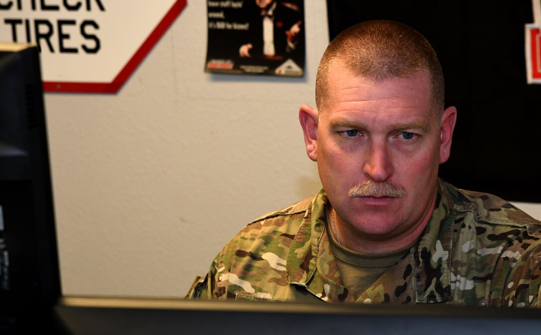 Photo of a U.S. Air Force foreign object damage manager working at his desk