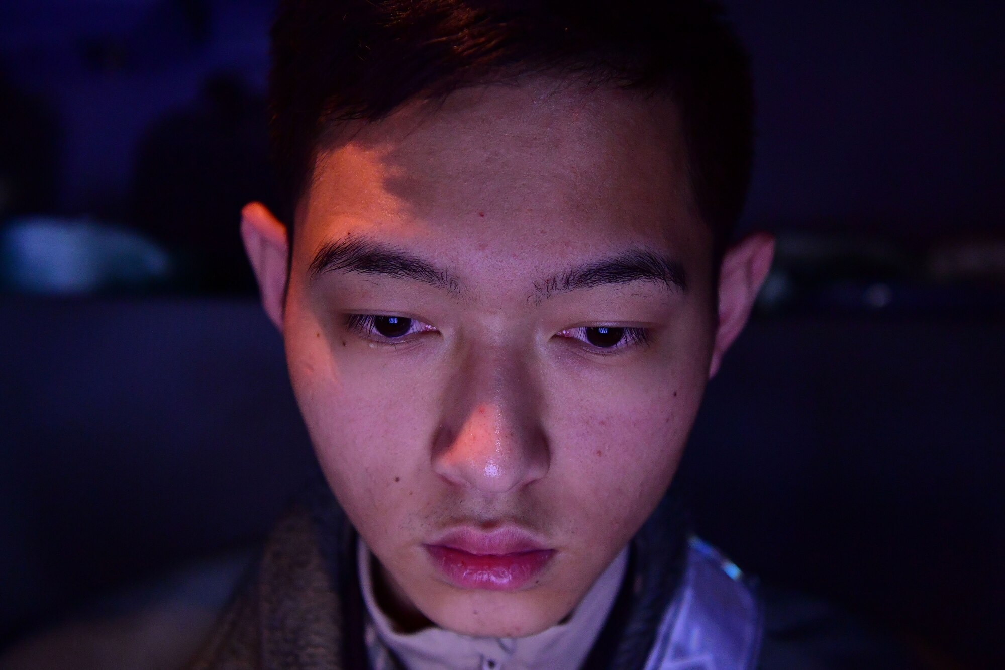 A man stares down.