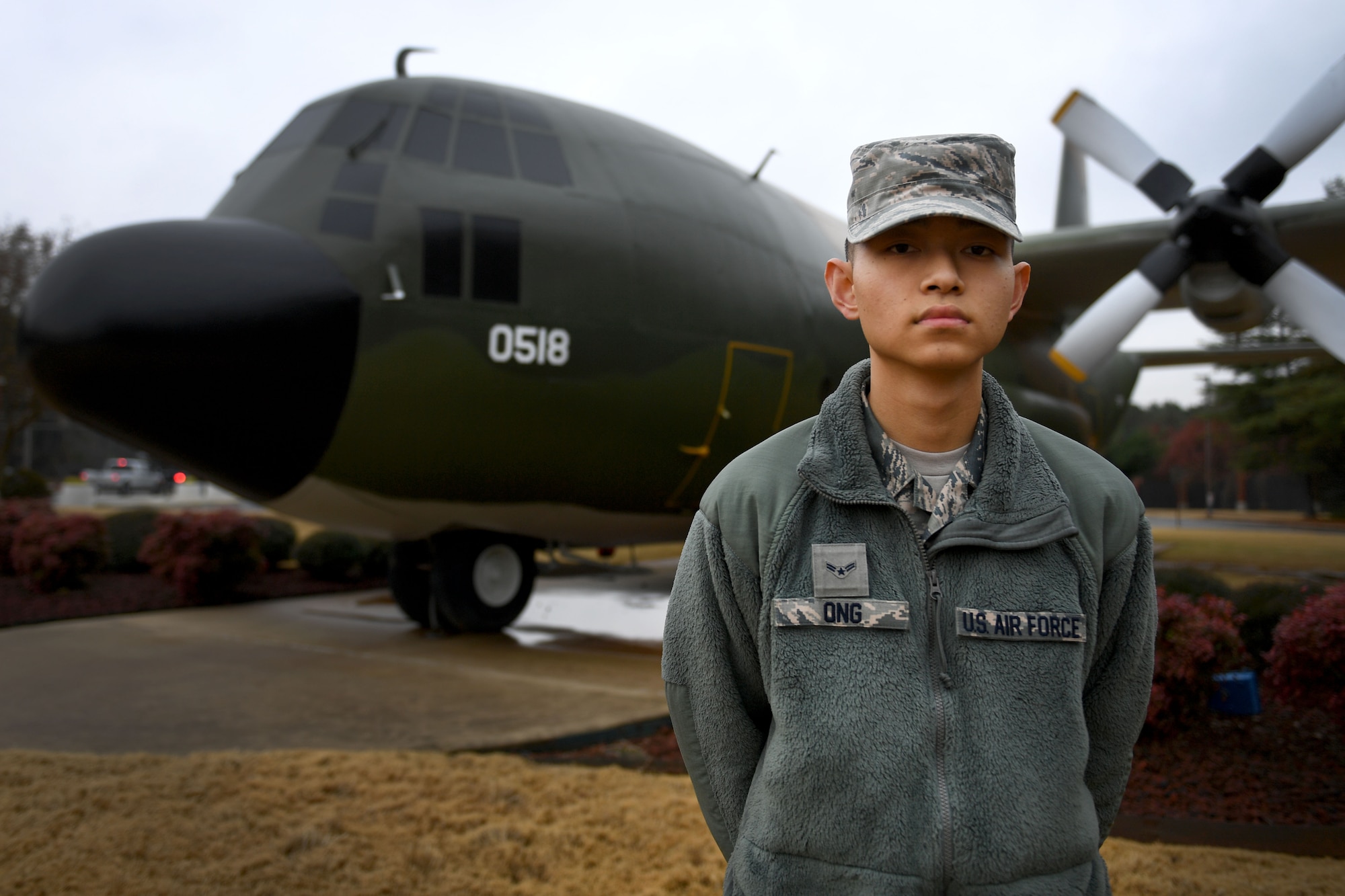A man stands in front of a plane.