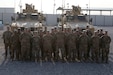Soldiers from the Syrian Logistics Cell, 103rd Expeditionary Sustainment Command, pose for a group photo Erbil, Iraq, Dec. 1, 2019.