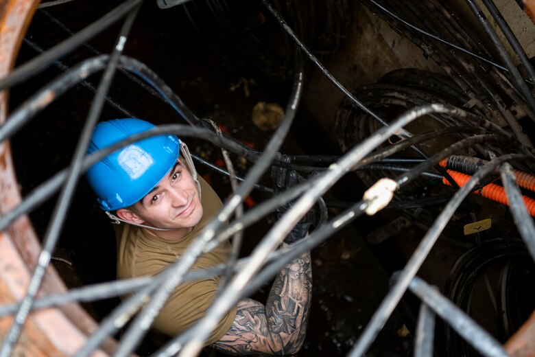 U.S. Air Force Airman 1st Class Trent Olson, 85th Engineering Installation Squadron cable antenna maintenance technician, sorts underground cabling at Tyndall Air Force Base, Florida, Dec. 9, 2019. Olson is part of a team working with the 325th Communications Squadron to relocate a node from a building that was damaged by Hurricane Michael. (U.S. Air Force photo by Tech. Sgt. Clayton Lenhardt)