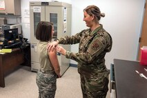 U.S. Air Force Kathryn Klein, right, an aerospace medical service specialist with 182nd Medical Group, Illinois Air National Guard, administers an influenza vaccination during drill weekend at the 182nd Airlift Wing in Peoria, Ill., Dec. 8, 2019. According to the Centers for Disease Control and Prevention, the flu is a contagious respiratory illness caused by influenza viruses, and the best prevention is getting a flu vaccine each year. (U.S. Air National Guard photo by Senior Airman Paul R. Helmig II)