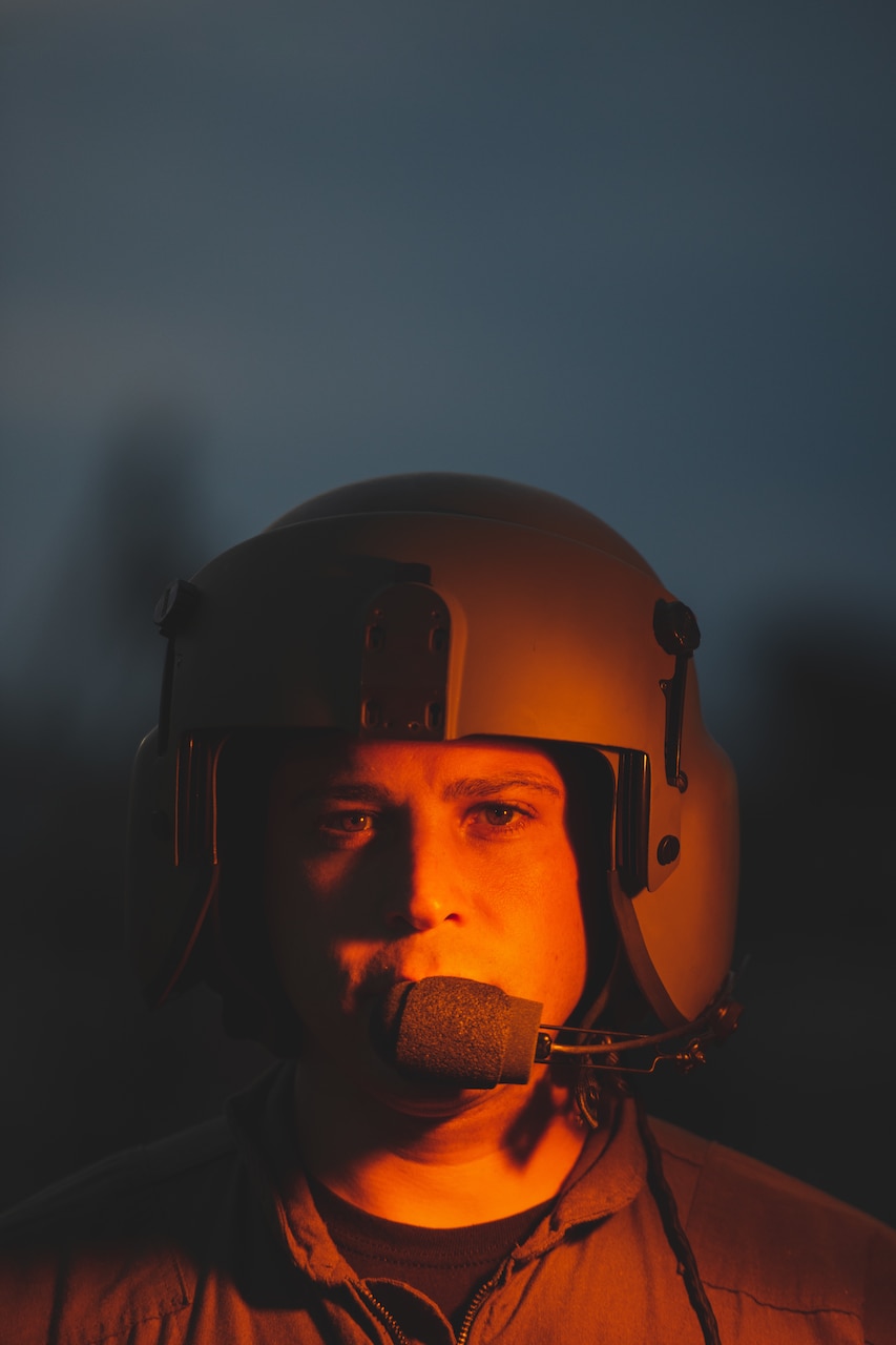 A man looking into the camera with a helmet on.