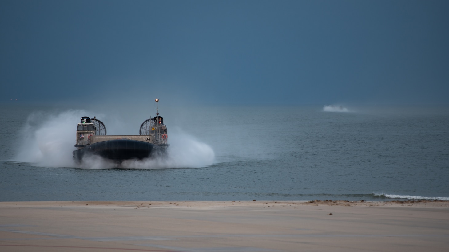 An LCAC on the water approaching the camera.