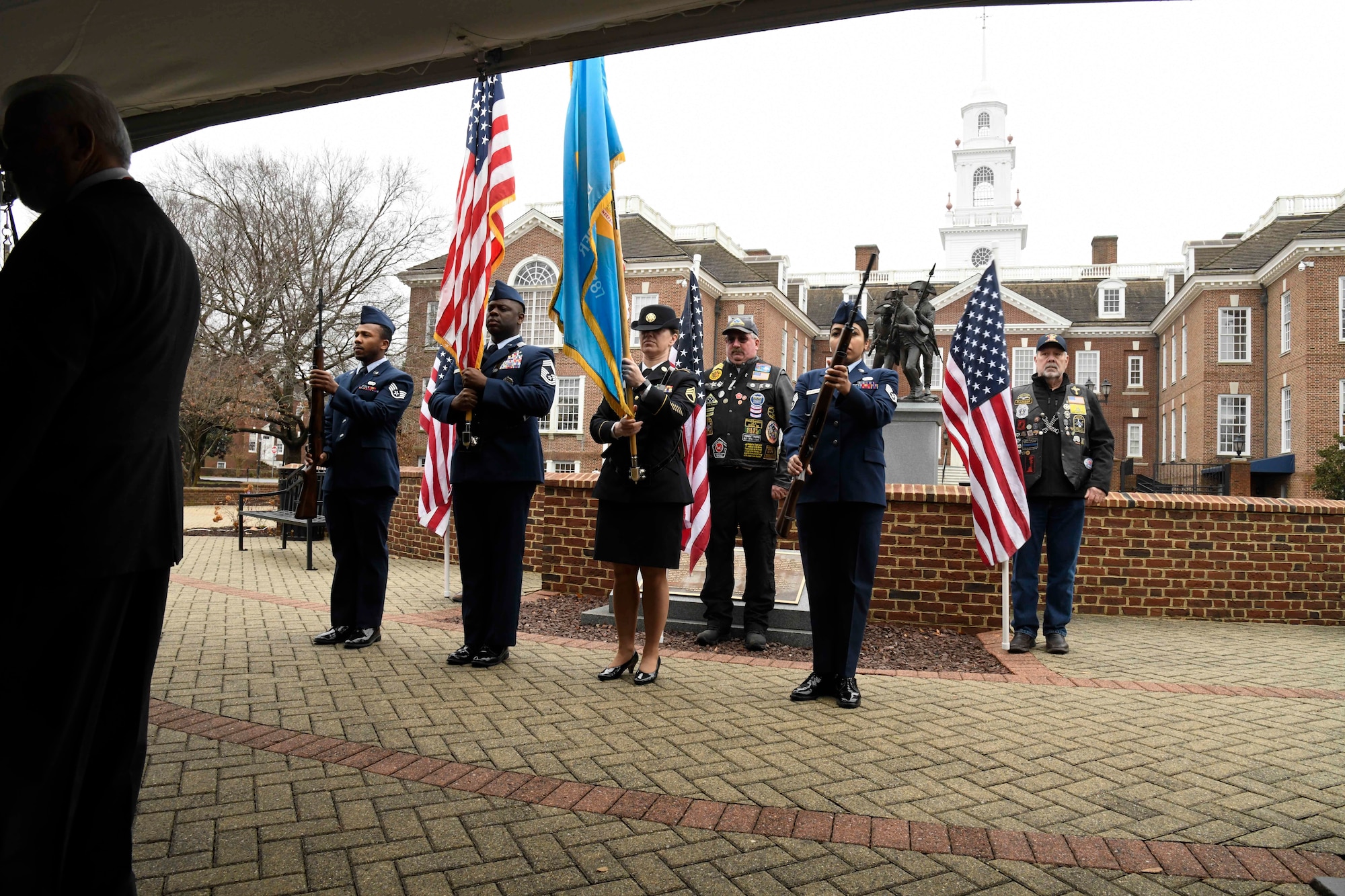 The Delaware Army National Guard Color Guard presents the colors during a Wreaths Across America (WAA) event in Dover, Del., Dec. 9, 2019. During the Dover WAA event, many local and military leaders spoke before joining children from a local elementary school to place wreaths at each of the memorials located around Legislative Mall. The annual WAA event is held at more than 1,600 locations, where volunteers lay wreaths at memorials and cemeteries in honor of those who served. The wreaths are symbolic: the evergreens represent longevity and endurance, the red bow represents great sacrifice, and the circular shape represents eternity. (U.S. Air Force photo by Senior Airman Eric M. Fisher)