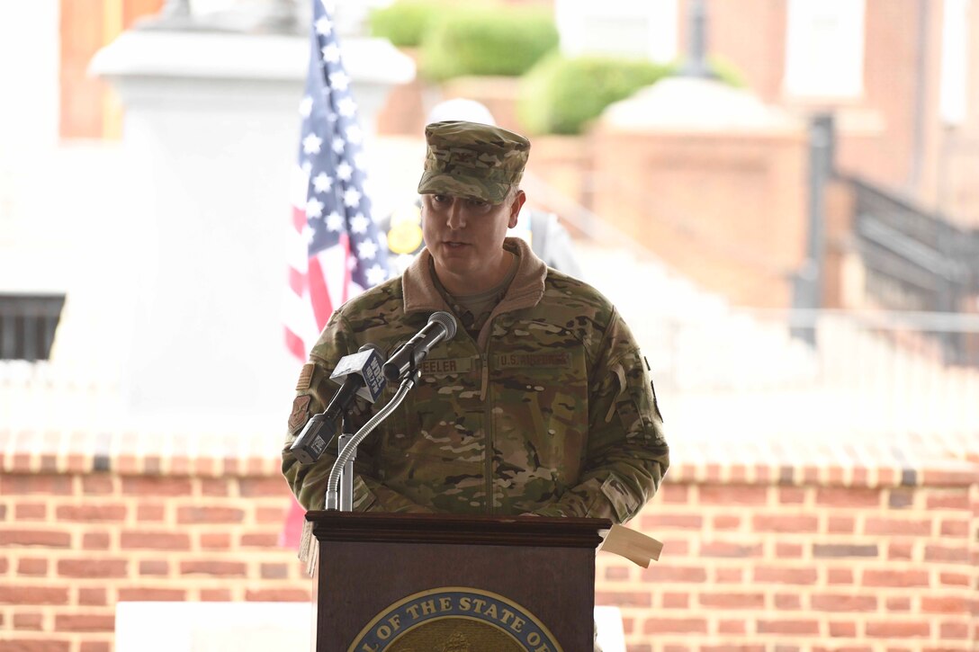 U.S. Air Force Col. Michael Peeler, 436th Operations Group commander, thanks the local community for their support during a Wreaths Across America (WAA) event in Dover, Del., Dec. 9, 2019. During the Dover WAA event, many local and military leaders spoke before joining children from a local elementary school to place wreaths at each of the memorials located around Legislative Mall. The annual WAA event is held at more than 1,600 locations, where volunteers lay wreaths at memorials and cemeteries in honor of those who served. The wreaths are symbolic: the evergreens represent longevity and endurance, the red bow represents great sacrifice, and the circular shape represents eternity. (U.S. Air Force photo by Senior Airman Eric M. Fisher)