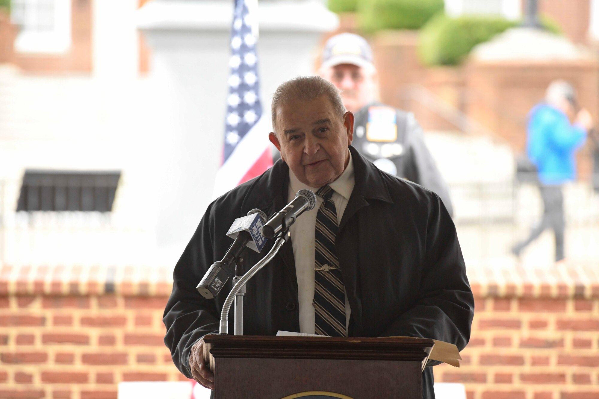U.S. Sen. Bruce C. Ennis discusses the Wreaths Across America mission (WAA) during a WAA event in Dover, Del., Dec. 9, 2019. During the Dover WAA event, many local and military leaders spoke before joining children from a local elementary school to place wreaths at each of the memorials located around Legislative Mall. The annual WAA event is held at more than 1,600 locations, where volunteers lay wreaths at memorials and cemeteries in honor of those who served. The wreaths are symbolic: the evergreens represent longevity and endurance, the red bow represents great sacrifice, and the circular shape represents eternity. (U.S. Air Force photo by Senior Airman Eric M. Fisher)