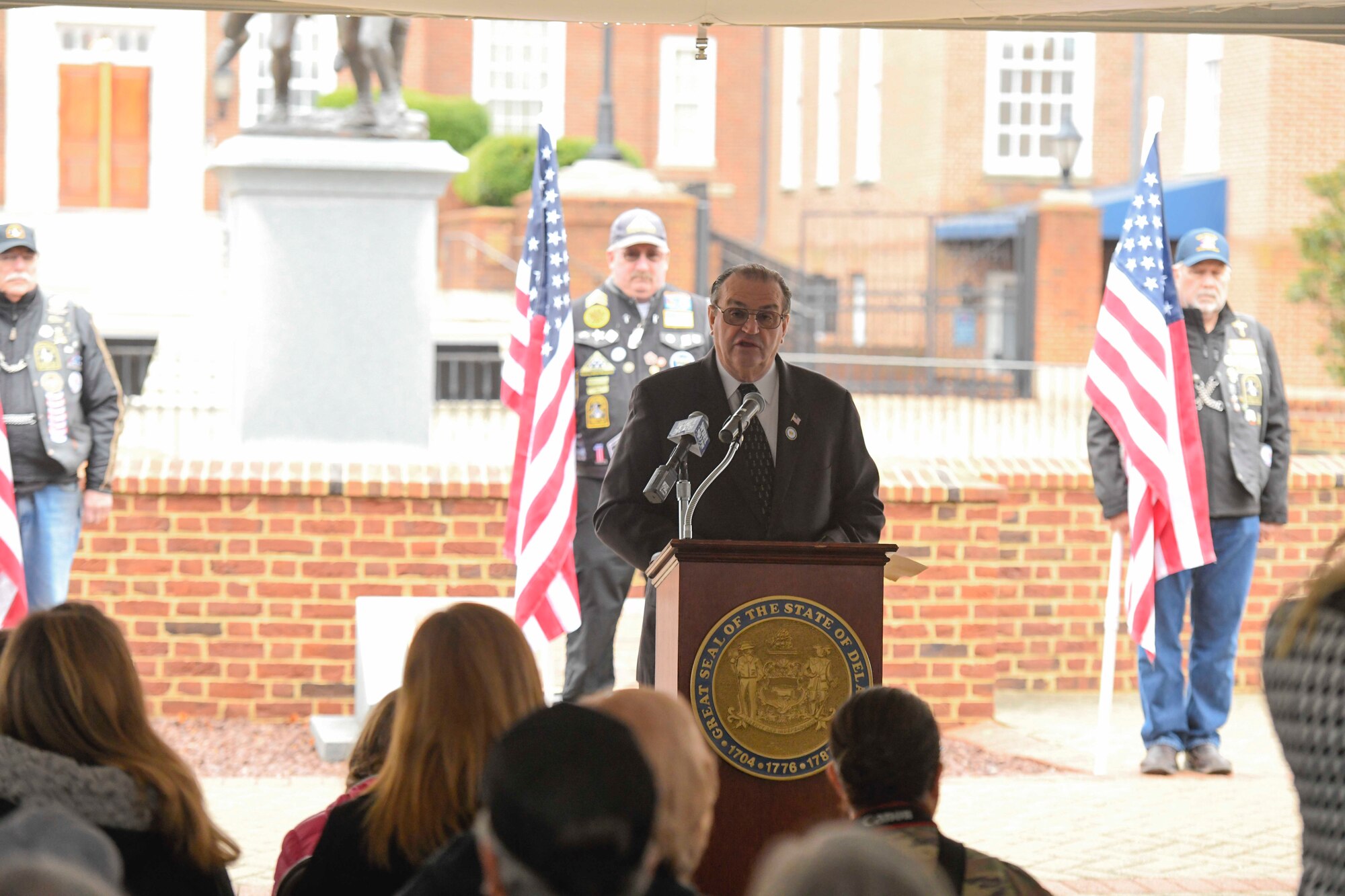 U.S. Rep. Earl Jacques speaks during a Wreaths Across America (WAA) event in Dover, Del., Dec. 9, 2019. During the Dover WAA event, many local and military leaders spoke before joining children from a local elementary school to place wreaths at each of the memorials located around Legislative Mall. The annual WAA event is held at more than 1,600 locations, where volunteers lay wreaths at memorials and cemeteries in honor of those who served. The wreaths are symbolic: the evergreens represent longevity and endurance, the red bow represents great sacrifice, and the circular shape represents eternity. (U.S. Air Force photo by Senior Airman Eric M. Fisher)