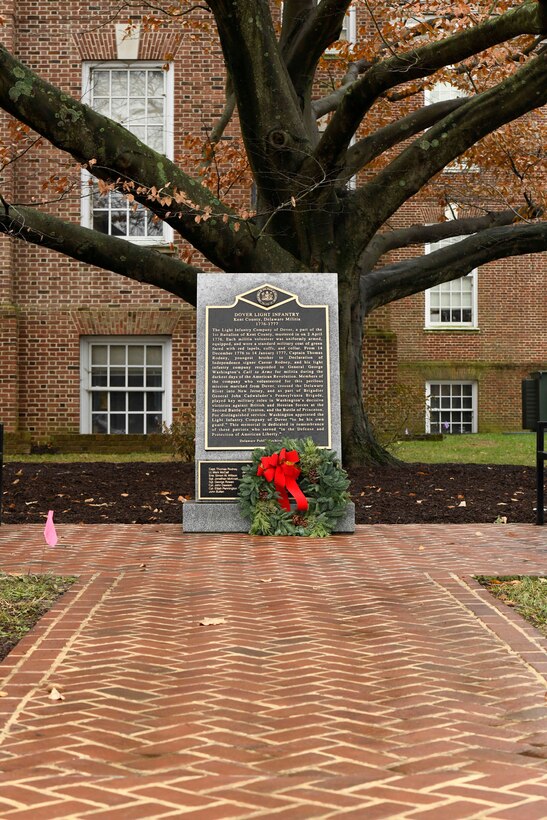 A wreath lies against the Dover Light Infantry Memorial in Dover, Del., Dec. 9, 2019. During the Dover WAA event, many local and military leaders spoke before joining children from a local elementary school to place wreaths at each of the memorials located around Legislative Mall. The annual WAA event is held at more than 1,600 locations, where volunteers lay wreaths at memorials and cemeteries in honor of those who served. The wreaths are symbolic: the evergreens represent longevity and endurance, the red bow represents great sacrifice, and the circular shape represents eternity. (U.S. Air Force photo by Senior Airman Eric M. Fisher)