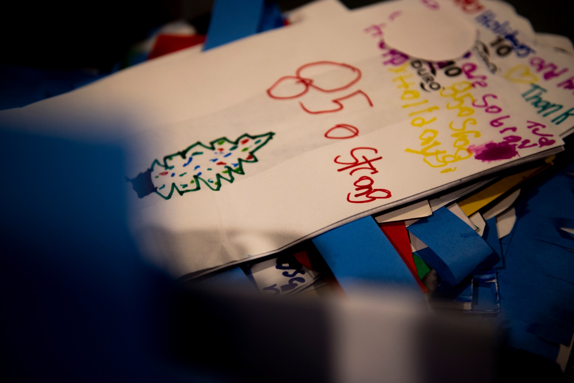 Handmade goodie bags made by students at Tyndall Elementary School, depicting holiday drawings and Panama City resiliency pictures, were used for a Cookie Caper event, at Tyndall Air Force Base, Florida, Dec. 9, 2019. The Tyndall Spouses Club and Tyndall First Sergeants collected hundreds of donated cookies to distribute to Airmen living in the on base dormitories, which were delivered in the colorful bags. (U.S. Air Force photo by Staff Sgt. Magen M. Reeves)