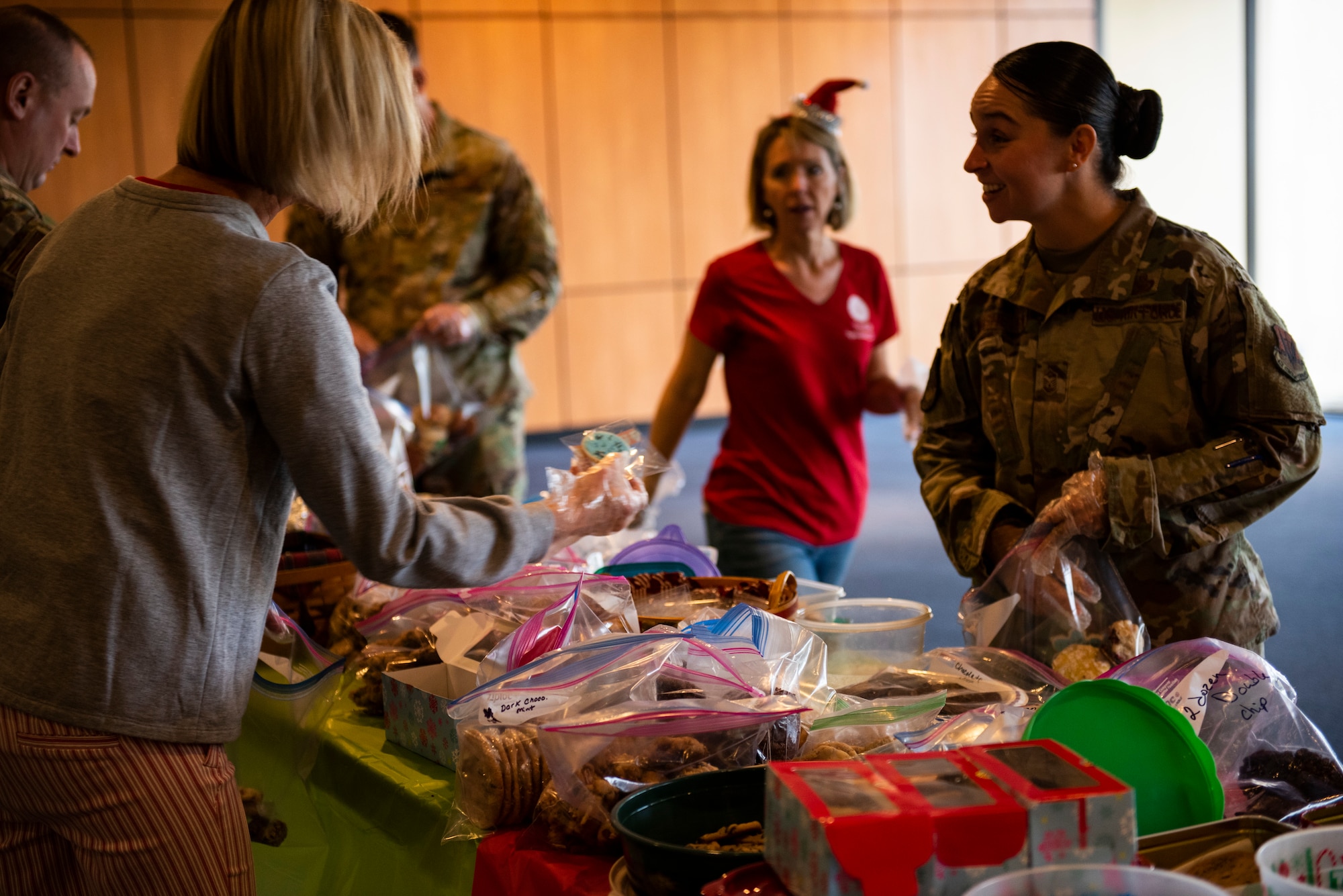 U.S. Air Force Master Sgt. Moriah Washburn, first sergeant to multiple units assigned to the 325th Mission Support Group, bags cookies at a Cookie Caper event at Tyndall Air Force Base, Florida, Dec. 9, 2019.  The Tyndall First Sergeants and Tyndall Spouses Club organized the event and collected hundreds of donated cookies to give to Airmen living in the on base dormitories, as well as delivering the extra cookies to base offices and units. (U.S. Air Force photo by Staff Sgt. Magen M. Reeves)