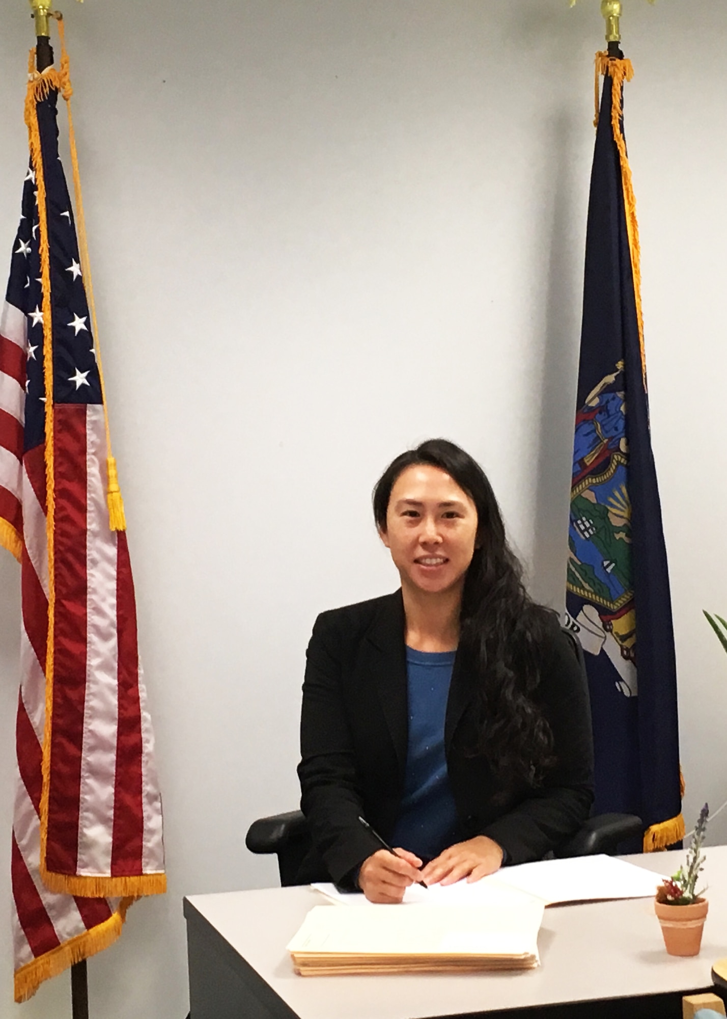 Senior Airman Ivory Lai, 459th Security Forces Squadron, poses for a photo at her civilian job where she serves as an administrative law judge for the state of New York. Though she has a successful law career, Lai made the decision to enlist in the Air Force Reserve to become a security a security forces member and "get the military experience". (U.S. Air Force photo/Staff Sgt. Cierra Presentado)