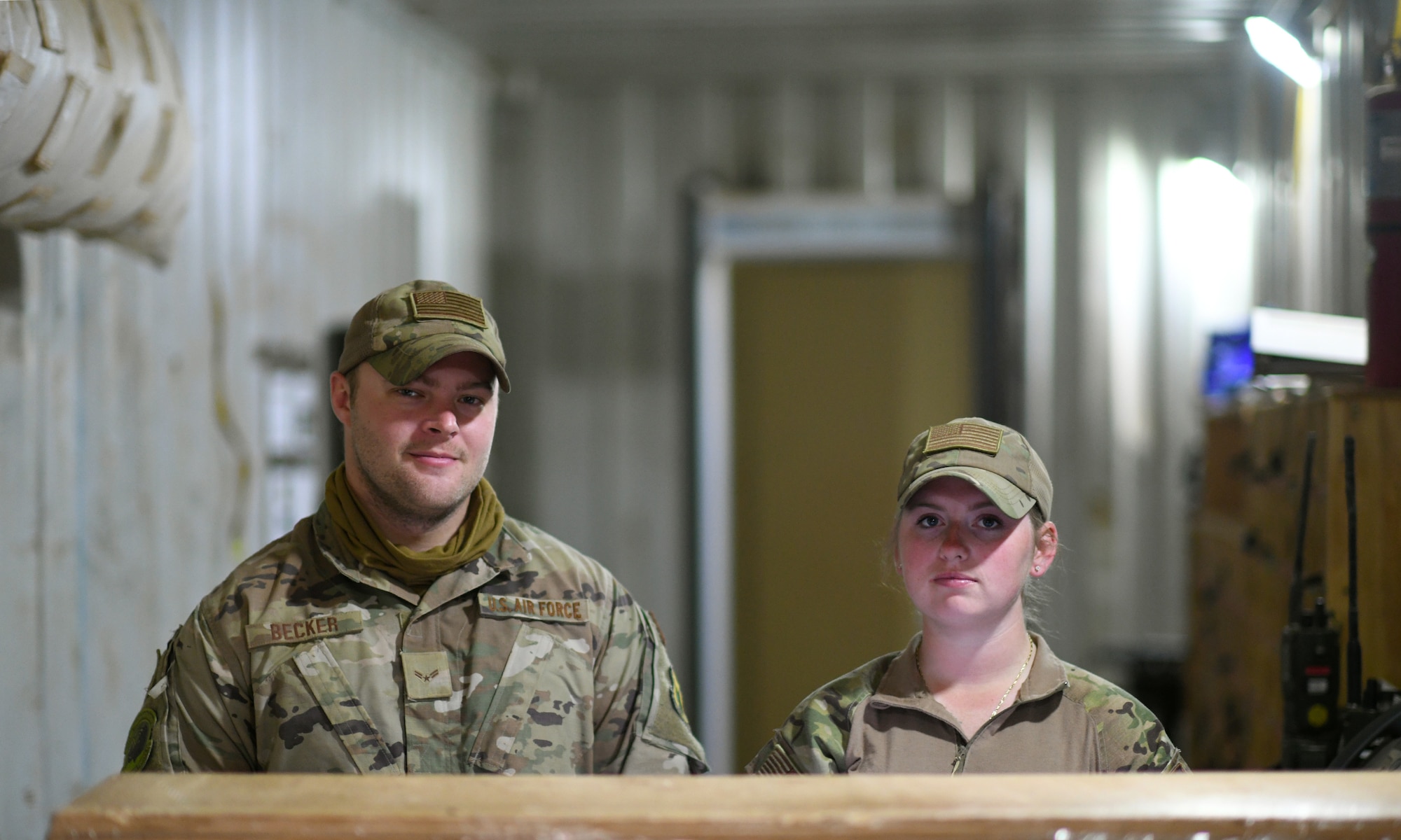 U.S. Air Force Airman 1st Class Austin Becker, left, and Senior Airman Kena Thomas, 409th Expeditionary Security Forces Squadron members, prepare to clear local contractors onto the installation in the badging office at Nigerien Air Base 201 in Agadez, Niger, Dec. 9, 2019. The 409th ESFS vigilantly defend the base and its assets through constant patrols, vehicle inspections and the vetting of all personnel working on the installation. (U.S. Air Force photo by Staff Sgt. Alex Fox Echols III)