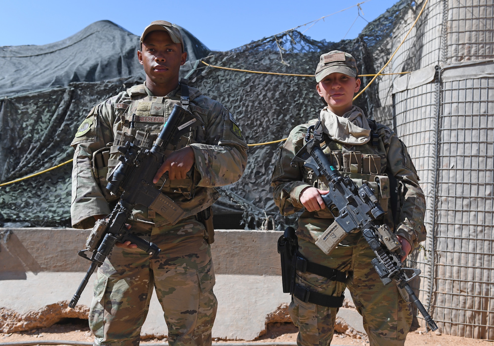 U.S. Air Force Staff Sgt. Noel Cheeseboro, left, and Senior Airman Gabrielle Hamilton, 409th Expeditionary Security Forces Squadron members, prepare to inspect vehicles at Nigerien Air Base 201 in Agadez, Niger, Dec. 9, 2019. The 409th ESFS vigilantly defend the base and its assets through constant patrols, vehicle inspections and the vetting of all personnel working on the installation. (U.S. Air Force photo by Staff Sgt. Alex Fox Echols III)