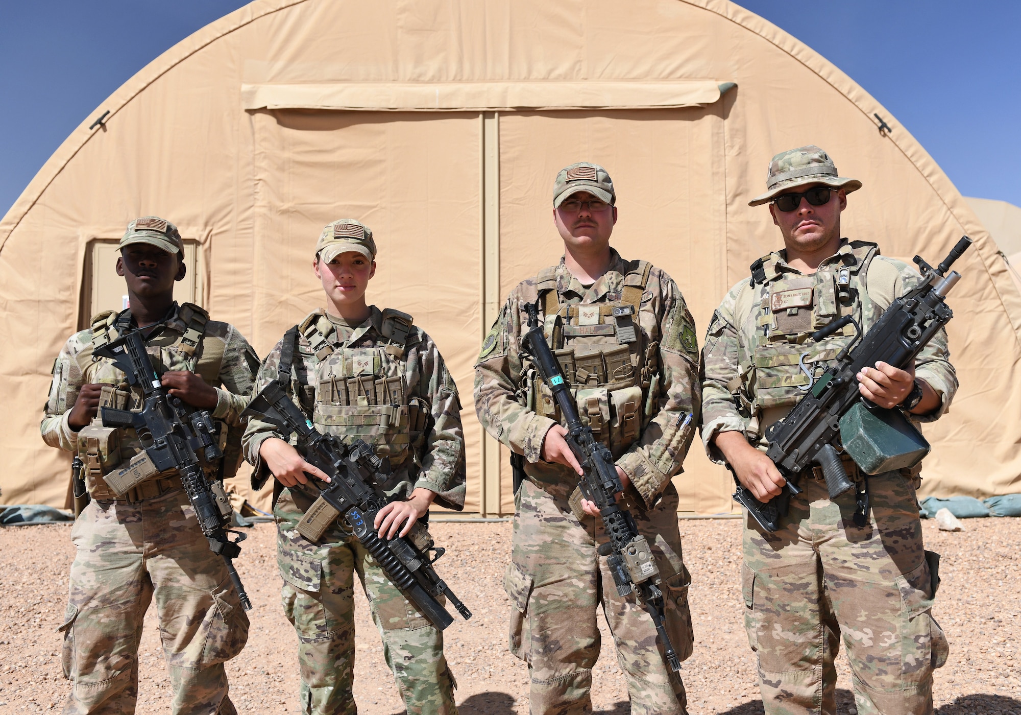 U.S. Air Force patrolmen deployed to the 409th Expeditionary Security Forces Squadron pose for a photo at Nigerien Air Base 201 in Agadez, Niger, Dec. 9, 2019. The 409th ESFS vigilantly defend the base and its assets through constant patrols, vehicle inspections and the vetting of all personnel working on the installation. (U.S. Air Force photo by Staff Sgt. Alex Fox Echols III)