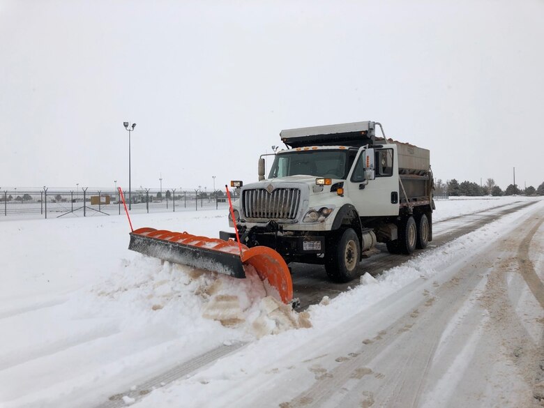 One of several snow trucks removes snow off the road during a recent snow storm on Schriever Air Force Base, Colorado. According to the 2019-20 snow and ice control pre-season brief, the first priority is removal of snow and ice immediately after a snow event. (U.S. Air Force courtesy photo)