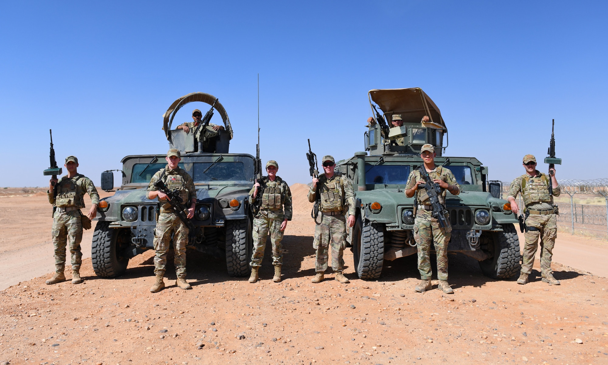 The 409th Expeditionary Security Forces Squadron’s Raptor 1 and 2 pose for a photo during their perimeter patrol at Nigerien Air Base 201 in Agadez, Niger, Dec. 9, 2019. The 409th ESFS vigilantly defend the base and its assets through constant patrols, vehicle inspections and the vetting of all personnel working on the installation. (U.S. Air Force photo by Staff Sgt. Alex Fox Echols III)