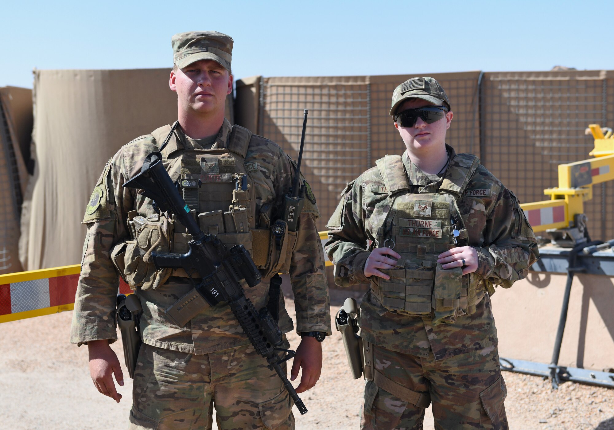 U.S. Air Force Airman 1st Class Bryson Carte, left, and Senior Airman Kitrina Thorne, 409th Expeditionary Security Forces Squadron members, monitor an entry control point at Nigerien Air Base 201 in Agadez, Niger, Dec. 9, 2019. The 409th ESFS vigilantly defend the base and its assets through constant patrols, vehicle inspections and the vetting of all personnel working on the installation. (U.S. Air Force photo by Staff Sgt. Alex Fox Echols III)