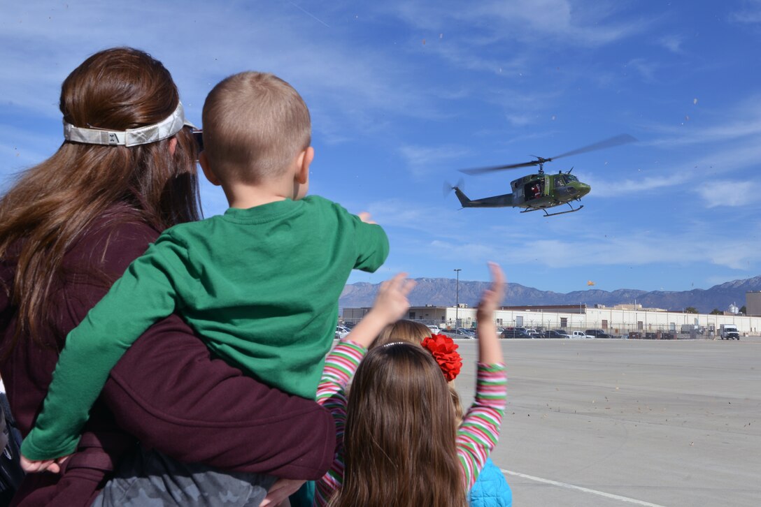 Santa Claus rides in on a UH-1N Huey Helicopter