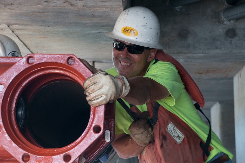 Contractors install a pressure valve on the fire suppression system at one of the wharfs on the Military Ocean Terminal Sunny Point, N.C. The system was damaged when Hurricane Florence struck the installation.