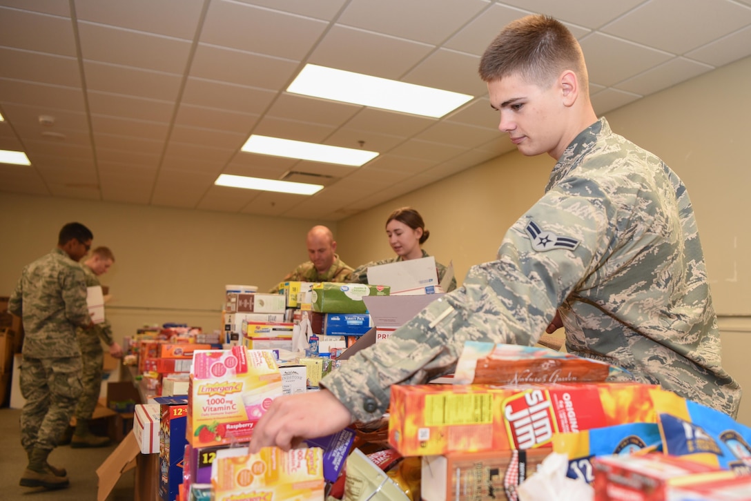 Airman 1st Class Nathan Martin, 373rd Training Squadron Detachment 8 Airman in training, helps pack care packages Dec. 2, 2019, at McConnell Air Force Base, Kan. Members from the Airman and Family Readiness Center on McConnell Air Force Base teamed up with the local community to put together care packages for Airmen currently deployed. (U.S. Air Force photo by Airman 1st Class Alexi Bosarge)