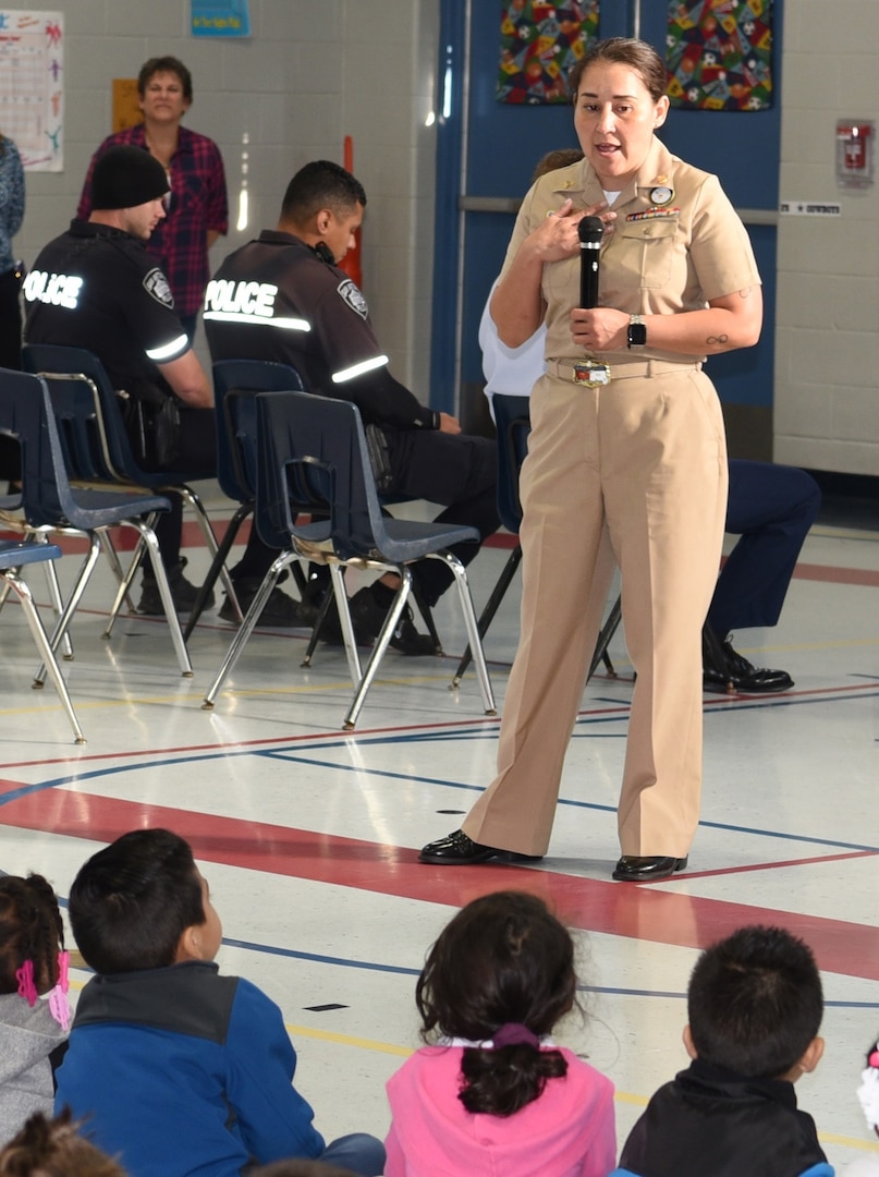 Chief Petty Officer Rosemarie Hagadus, assigned to Navy Recruiting District San Antonio, speaks with students of Dorie Miller Elementary during the school’s annual Pearl Harbor and Dorie Miller Remembrance Program.  The event was held in remembrance of those who fought and for those who lost their lives Dec. 7, 1941.