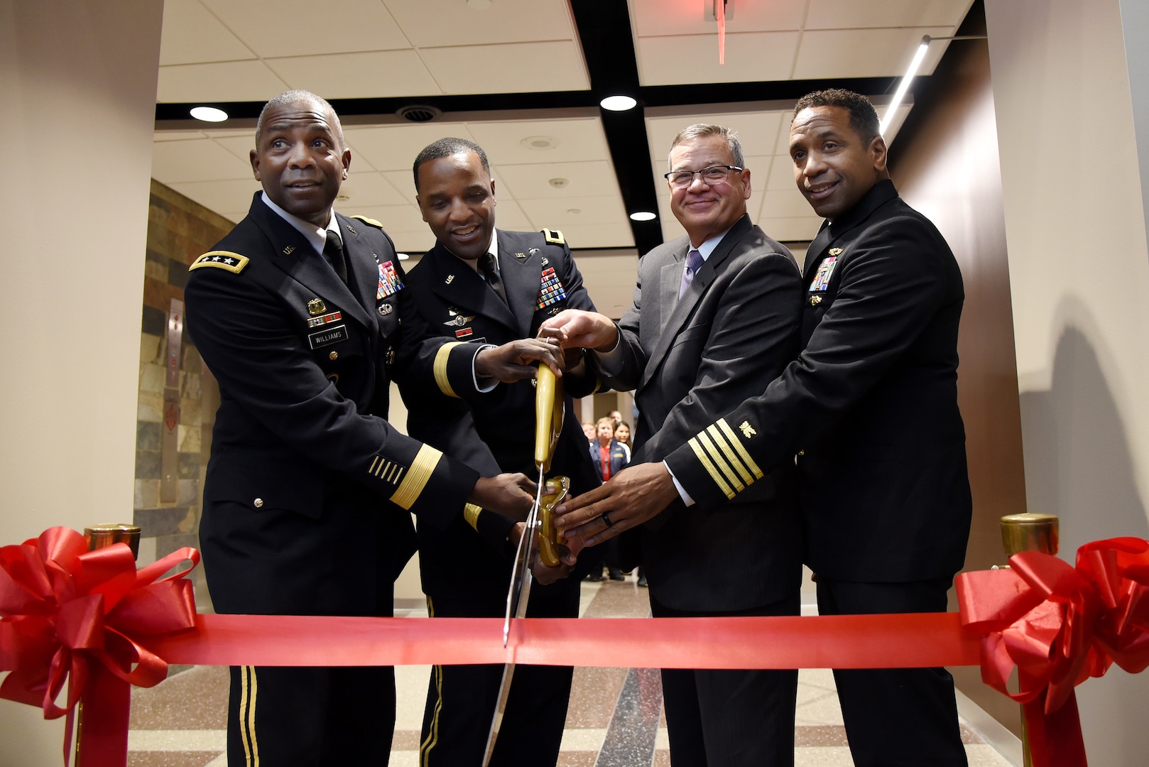 The Defense Logistics Agency Troop Support celebrated the opening of its new headquarters building in Philadelphia during a ribbon cutting ceremony on Dec. 10, 2019. Pictured are, from the left, Army Lt. Gen. Darrell Williams, director, Defense Logistics Agency (DLA); Army Brig. Gen. Gavin Lawrence, commander, DLA Troop Support; Richard Ellis, deputy commander, DLA Troop Support; and Navy Capt. Preston Gill, commanding officer, Naval Support Activity (NSA) Mechanicsburg. (U.S. Navy photo by Mass Communication Specialist 2nd Class Anthony Flynn/Released)