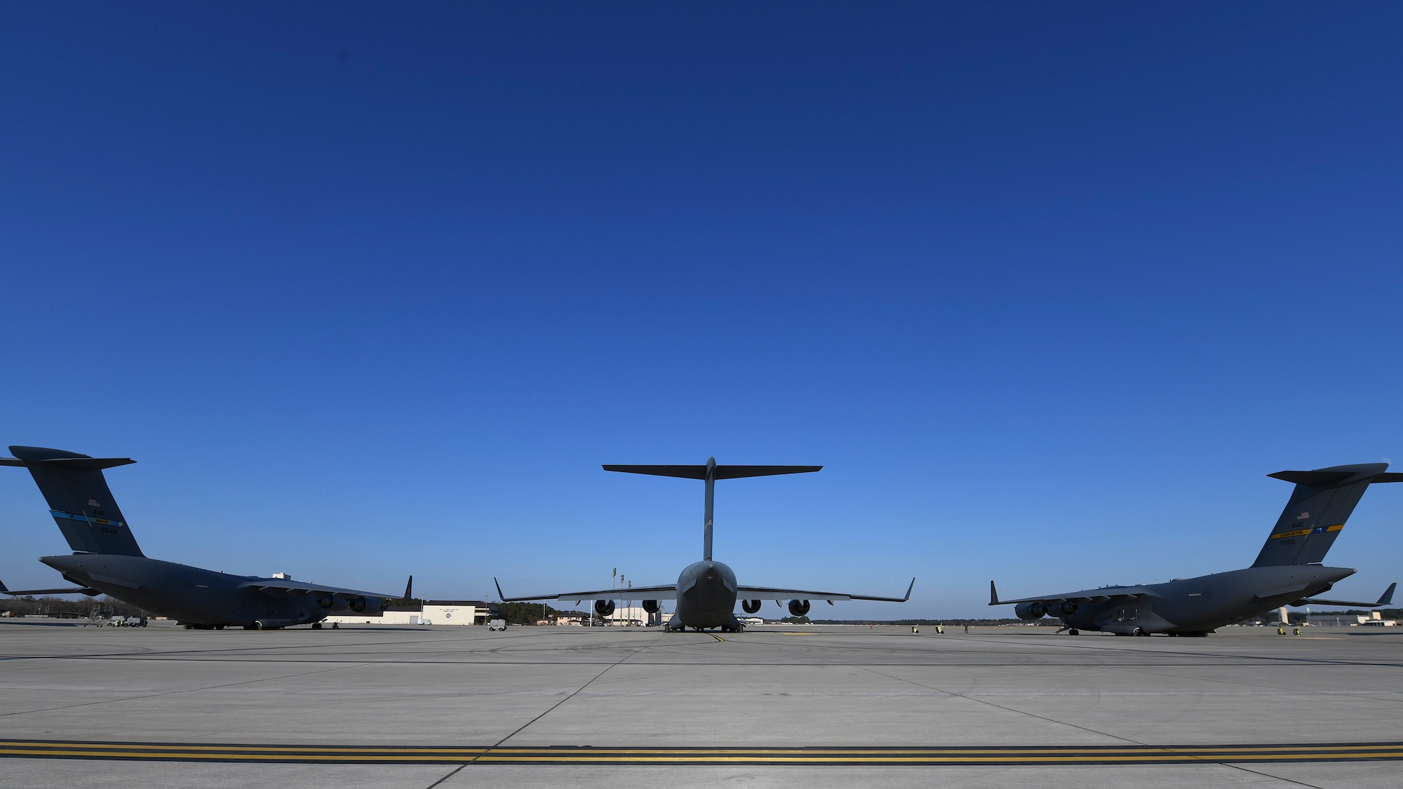 Three C-17 Globemaster III’s were prepped for takeoff at Pope Army Airfield N.C., December 7, 2019. The 437th Airlift Wing staged at Pope to load the 82nd Airborne assigned to Fort Bragg, N.C.. The 437th AW supported Joint Forcible Entry 19B by sending the a three-ship to the Nevada Testing and Training Range to conduct personnel airdrop operations with the 82nd Airborne, three other C-17 Globemaster III’s, and 17 C-130J Hercules. (Photo by Staff Sergeant Lance Valencia)