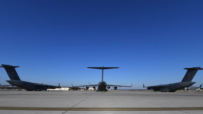 Three C-17 Globemaster III’s were prepped for takeoff at Pope Army Airfield N.C., December 7, 2019. The 437th Airlift Wing staged at Pope to load the 82nd Airborne assigned to Fort Bragg, N.C.. The 437th AW supported Joint Forcible Entry 19B by sending the a three-ship to the Nevada Testing and Training Range to conduct personnel airdrop operations with the 82nd Airborne, three other C-17 Globemaster III’s, and 17 C-130J Hercules. (Photo by Staff Sergeant Lance Valencia)
