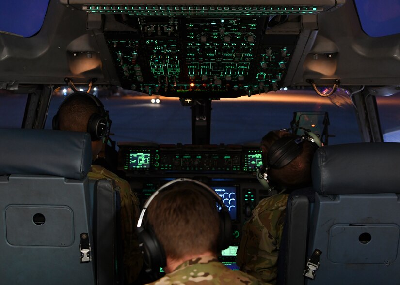 Capt. Nicholas Cox, a pilot instructor, and Capt. Jacob Nations, copilot assigned to the 16th Airlift Squadron at Joint Base Charleston, S.C., conducted pre-flight checks at Pope Army Airfield N.C., December 7, 2019. The 16th AS staged at Pope to load the 82nd Airborne assigned to Fort Bragg, N.C.. The 437th Airlift Wing supported Joint Forcible Entry 19B by sending the a three-ship to the Nevada Testing and Training Range to conduct personnel airdrop operations with the 82nd Airborne, three other C-17 Globemaster III’s, and 17 C-130J Hercules. (Photo by Staff Sergeant Lance Valencia)