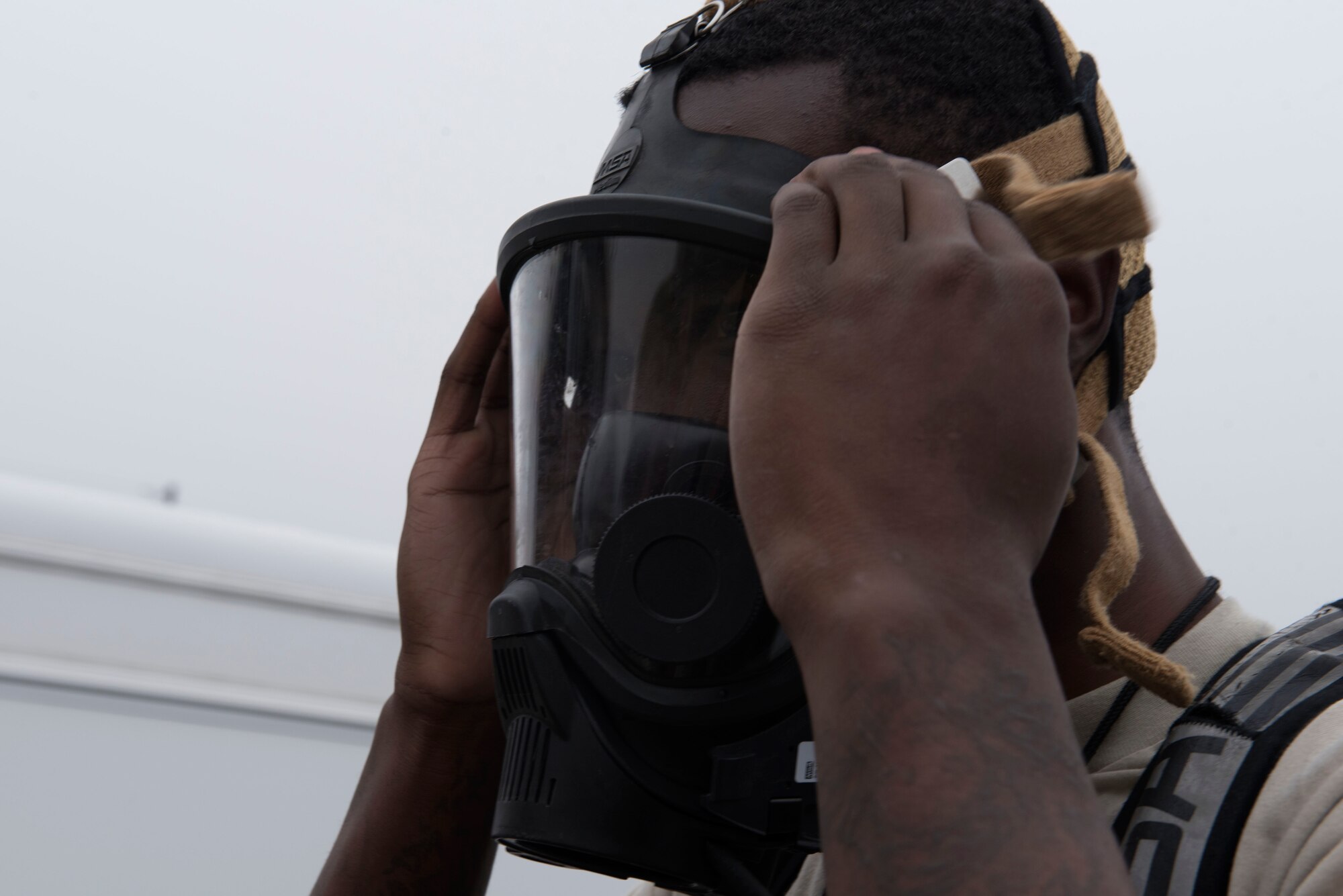 Airman 1st Class Cameron Butler, 4th Civil Engineer Squadron emergency management hazardous material team technician, dons a gasmask during a Hazardous Material Spill Response exercise, Dec. 9, 2019, in Goldsboro, N.C.