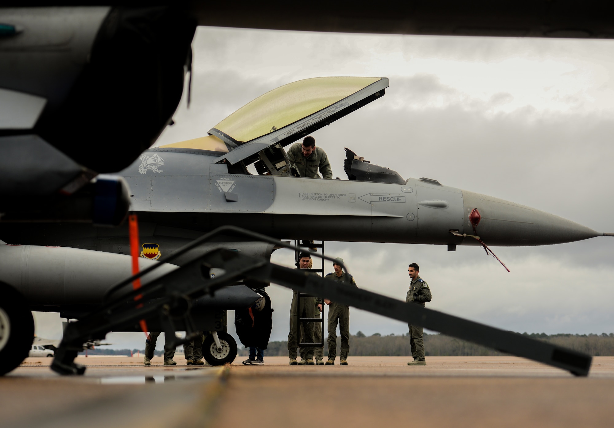 An Airman examines the interior of an F-16 Fighting Falcon Dec. 10, 2019, at Columbus Air Force Base, Miss. In an air combat role, the F-16's maneuverability and combat radius (distance it can fly to enter air combat, stay, fight and return) exceed that of all potential threat fighter aircraft. (U.S. Air Force photo by Airman Davis Donaldson)