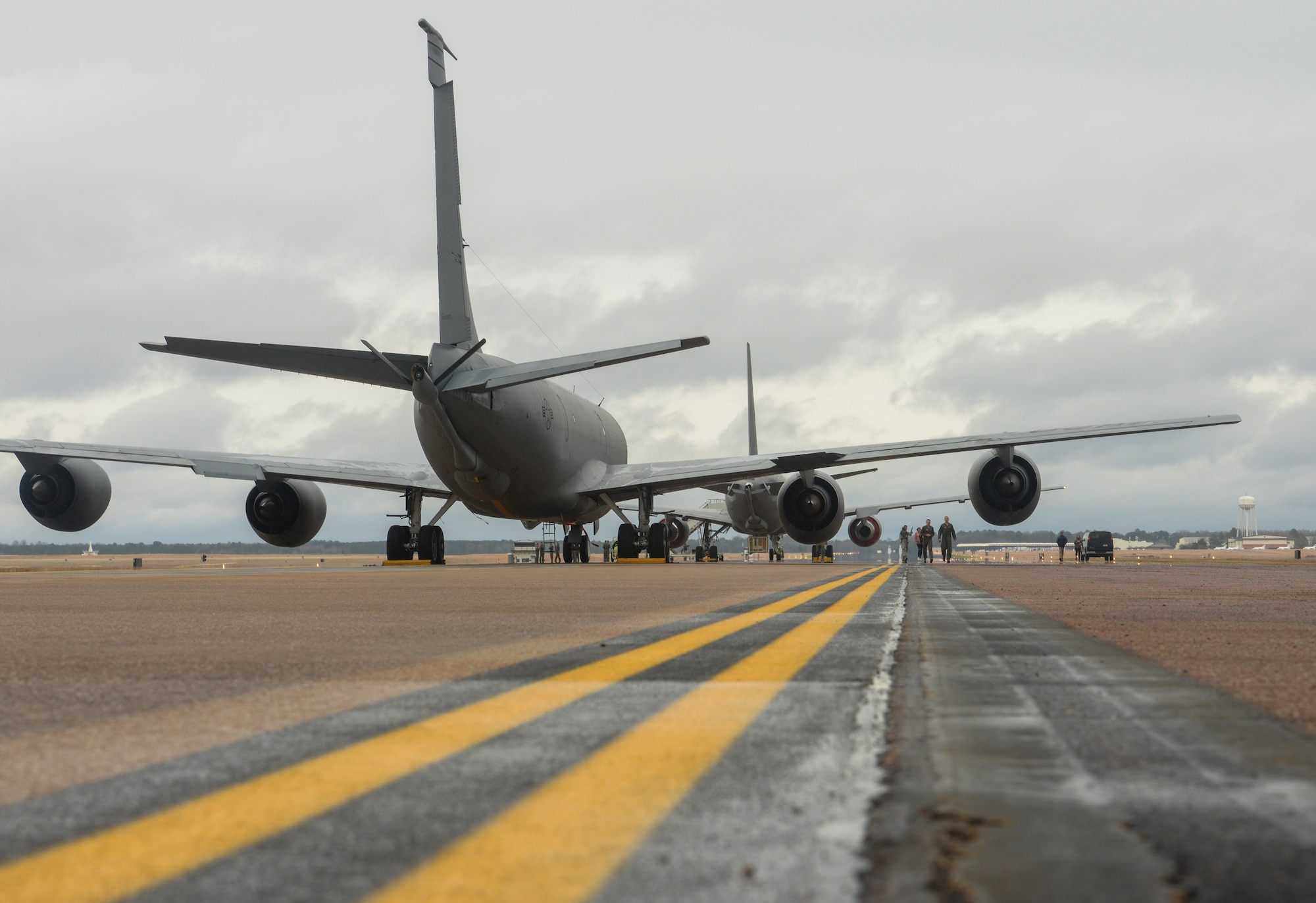 Airmen walk under the wing of a KC-135 Stratotanker Dec. 10, 2019, at Columbus Air Force Base, Miss. The KC-135 Stratotanker provides the core aerial refueling capability for the United States Air Force and has excelled in this role for more than 60 years. (U.S. Air Force photo by Airman Davis Donaldson)