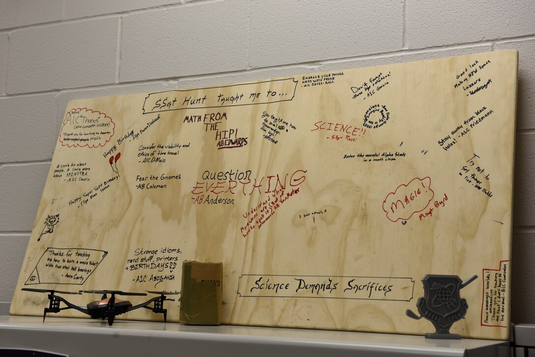 U.S. Air Force Staff Sgt. David Hunt, 312th Training Squadron Special Instrument Training instructor, displays a plaque signed by his students at the Louis F. Garland Department of Defense Fire Academy Nov. 21, 2019. Hunt invited his student to sign and leave a message so that he will have something to remember them by after graduating. (U.S. Air Force photo by Airman 1st Class Zachary Chapman)