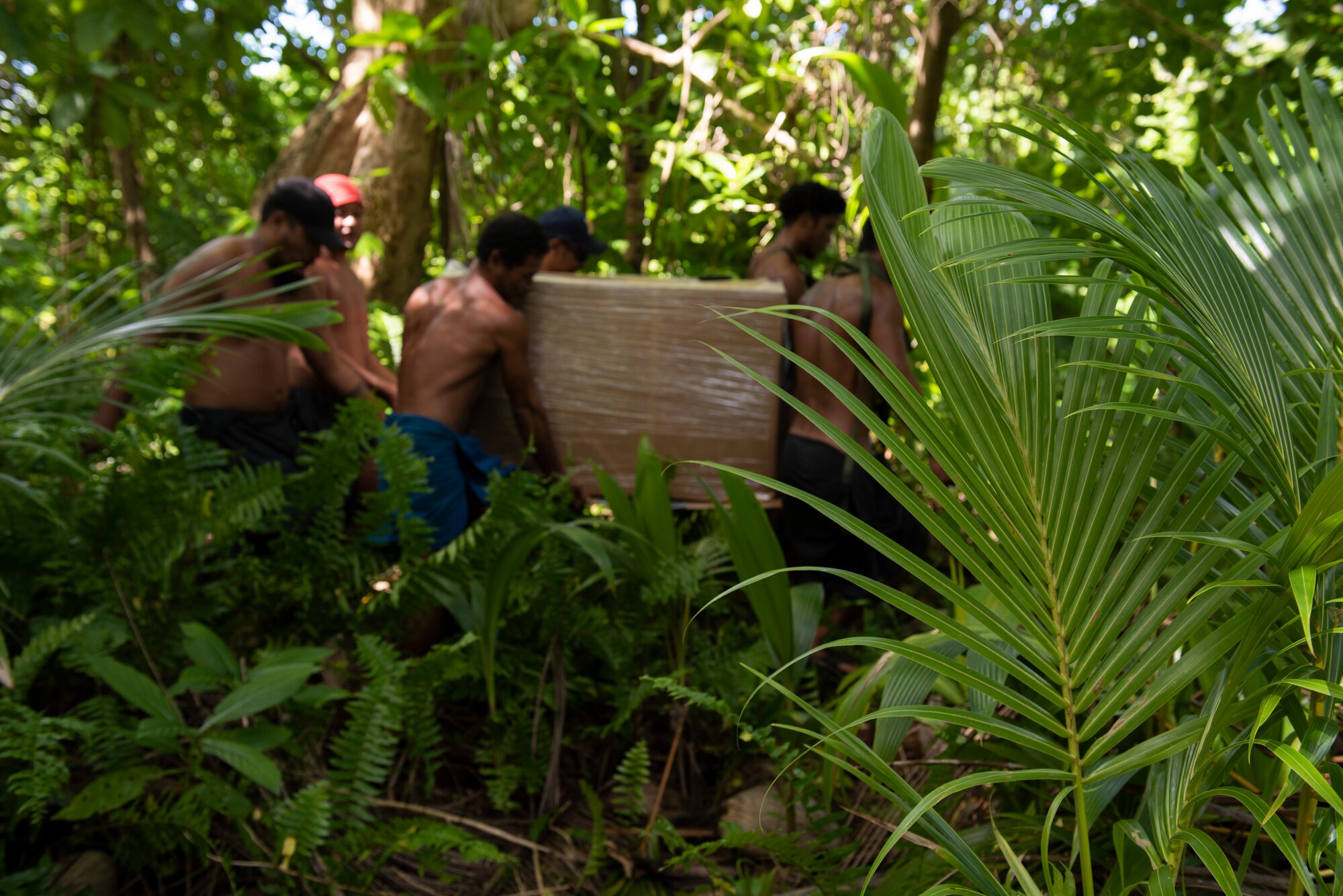 A group of six villagers work togethe