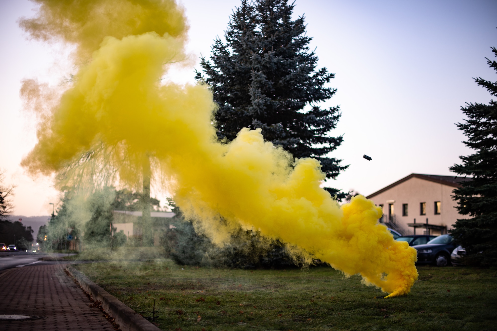 Yellow smoke disperses into the air during exercise Operation Varsity 19-04 at Ramstein Air Base, Germany, Dec. 10, 2019. The smoke simulated a chemical attack, adding realism to the exercise which is designed to test Airmen’s response to chemical, biological, radiological, nuclear and explosive attacks. (U.S. Air Force photo by Staff Sgt. Devin Boyer)