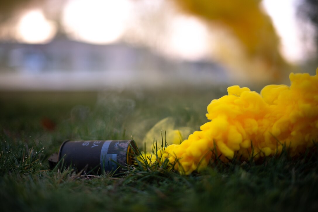 Yellow smoke disperses into the air during exercise Operation Varsity 19-04 at Ramstein Air Base, Germany, Dec. 10, 2019. The smoke simulated a chemical attack, adding realism to the exercise which was designed to test Airmen’s response to chemical, biological, radiological, nuclear and explosive attacks. (U.S. Air Force photo by Staff Sgt. Devin Boyer)