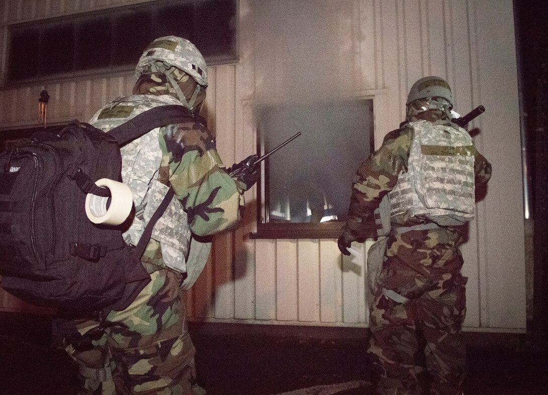 U.S. Air Force personnel assigned to the 86th Logistics Readiness Squadron petroleum, oils and lubricants flight, discover a simulated building fire during Exercise Operation Varsity 19-04 at Ramstein Air Base, Germany, Dec. 10, 2019. According to the exercise scenario, the building caught fire after sustaining explosive damage from an attack. Personnel practiced response procedures, such as building evacuation and relocation of explosive material. The scenario was designed to sharpen their response time and effectiveness.
