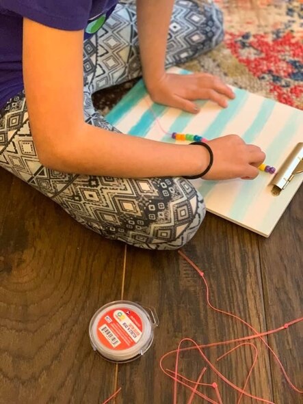 Girl makes bracelets