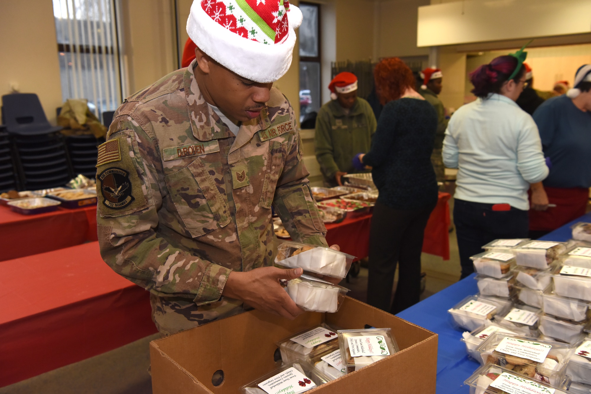 Technical Sgt. Skylar DeRouen, 752nd Special Operations Group munitions production section chief, packages holiday cookies prior to delivery during the annual Holiday Cookie Drive at RAF Mildenhall, England, Dec. 12, 2019. The cookie drive takes place during the first part of December to provide base dorm residents a comforting taste of home in the form of cookies. (U.S. Air Force photo by Senior Airman Brandon Esau)