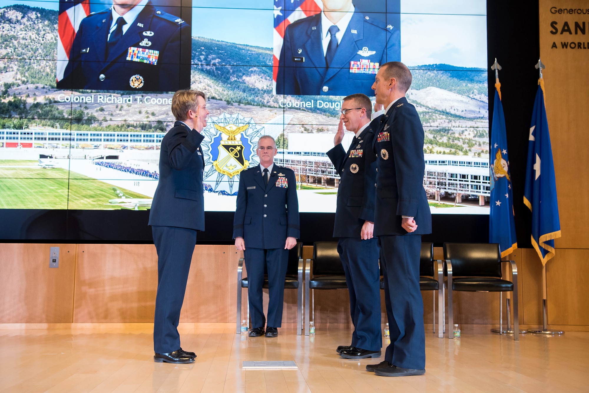The dean of faculty, Brig. Gen. Linell Letendre, swears in the new permanent professors alongside the Academy superintendent, Lt. Gen. Jay Silveria, during an investiture ceremony in Polaris Hall at the U.S. Air Force Academy, Colo., Dec. 6, 2019. The new professors invested include Col. Richard Cooney, department of behavioral sciences and leadership, and Col. Douglas Wickert, department of aeronautics. (U.S. Air Force photo by Trevor Cokley)