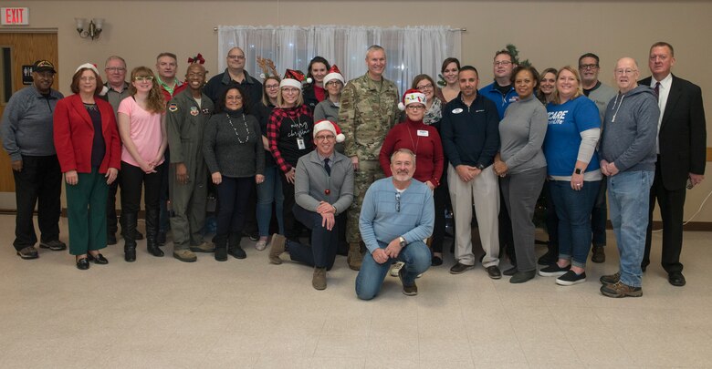 Members of the Bellevue Chamber of Commerce stand with Offutt Air Force Base leadership following operation holiday cheer Dec. 10, 2019. The chamber held the event to make holiday cheer bags for dormitory  residents here.